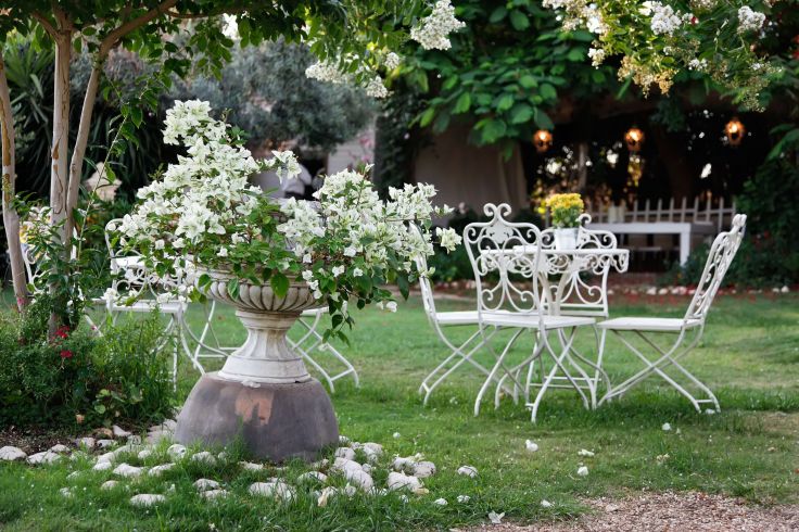 12925011 - white table and chairs in beautiful garden